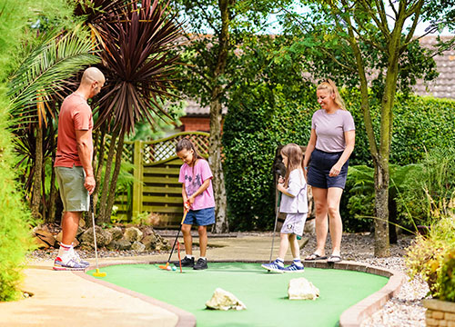 Family playing adventure golf